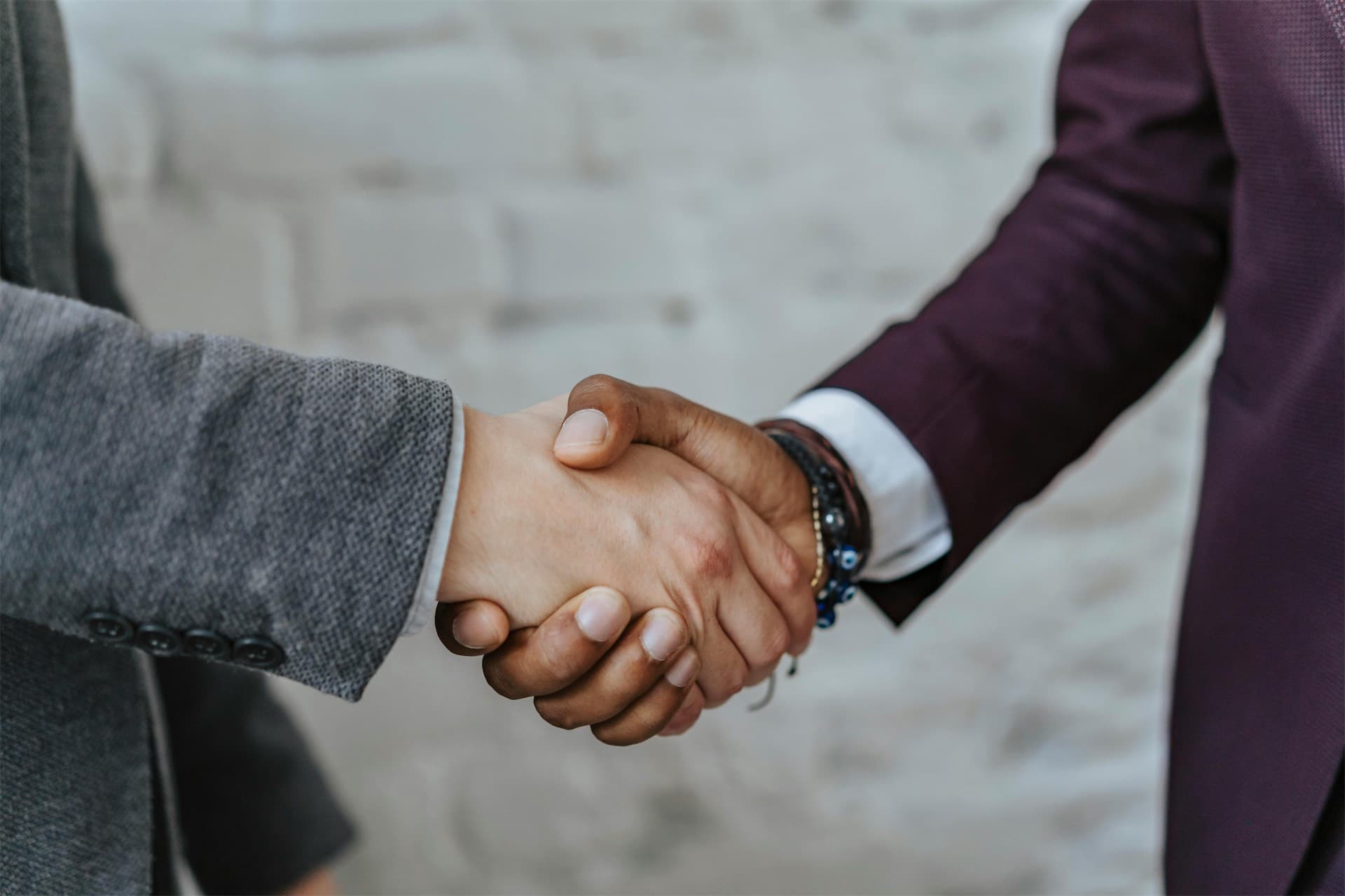 Handshake over legal documents representing settlement in debt claims