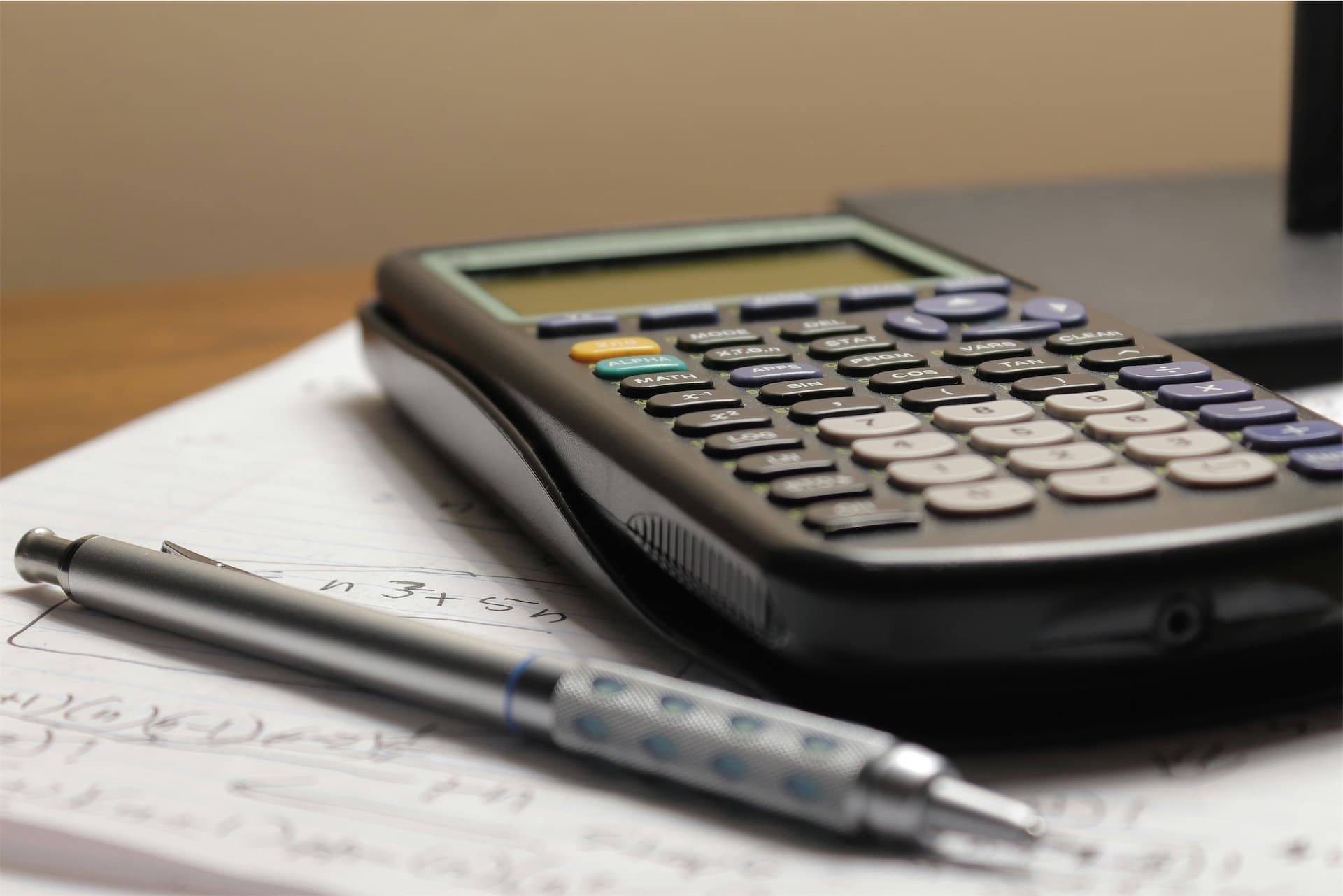 Calculator and coins representing interest charges on debts